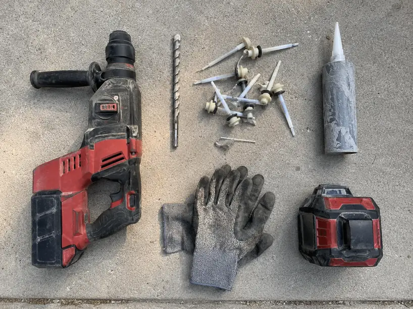 Concrete leveling and lifting tools laid out on a job site in Ellicott City, MD