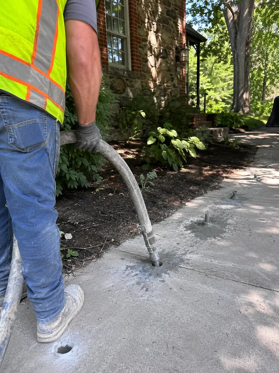 Mudjacking a settled concrete walkway in Ellicott City, MD
